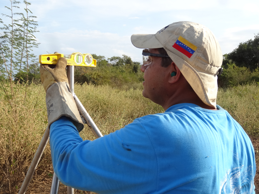 Ricardo Lopez uses a level to make sure the monument was drilled correctly.