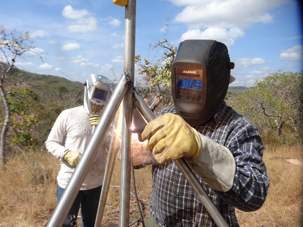 John Sandru welds the monument together while another team member looks on.
